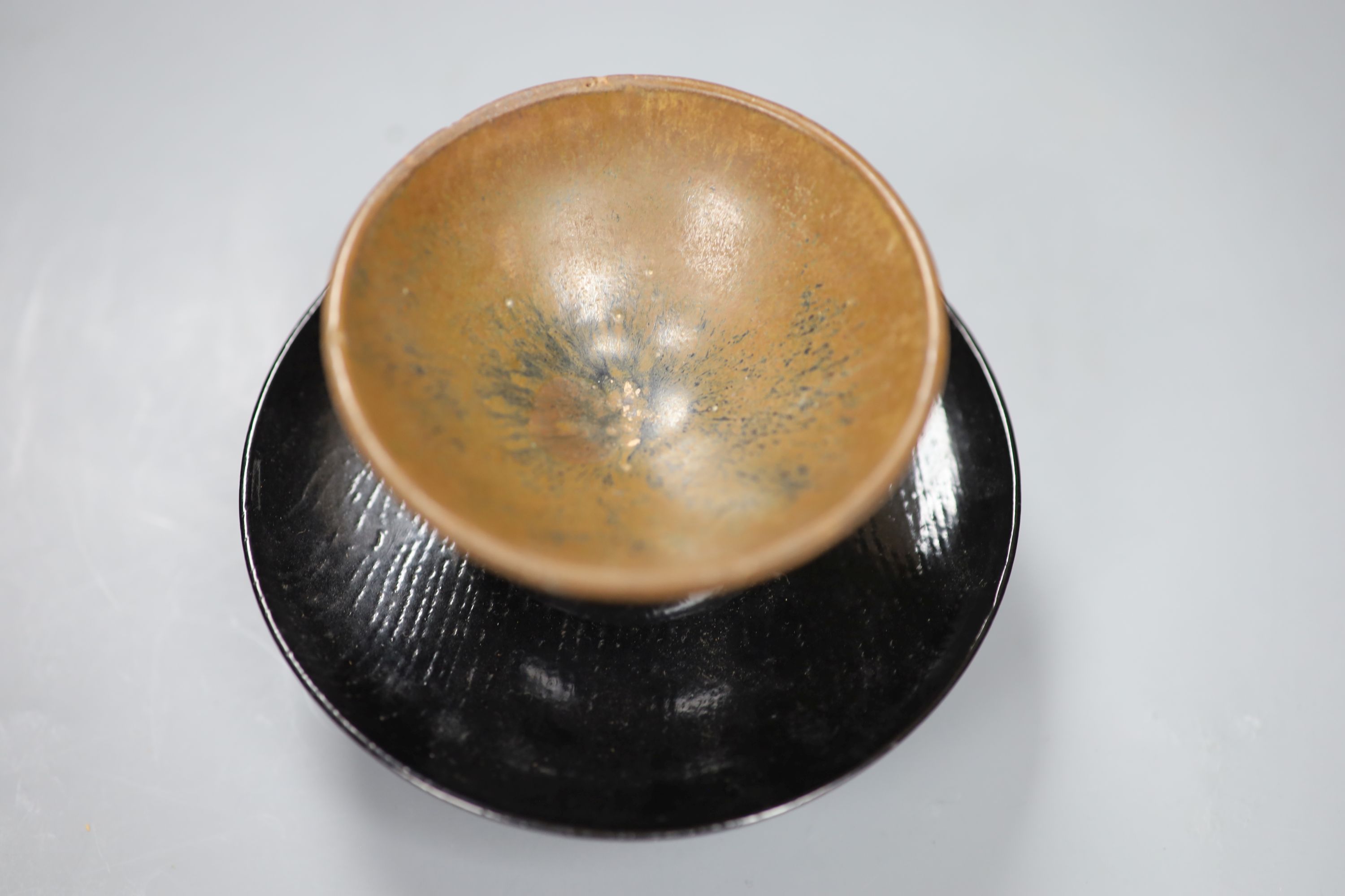 A Chinese Tenmoku tea bowl, diameter 9.5cm, and a lacquer stand